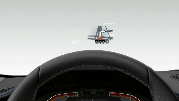 BMW 3-serie Sedan, BMW Head-Up Display. Närbild av halva ratten och vindrutan med BMW Head-Up Display i BMW 3-serie Sedan.