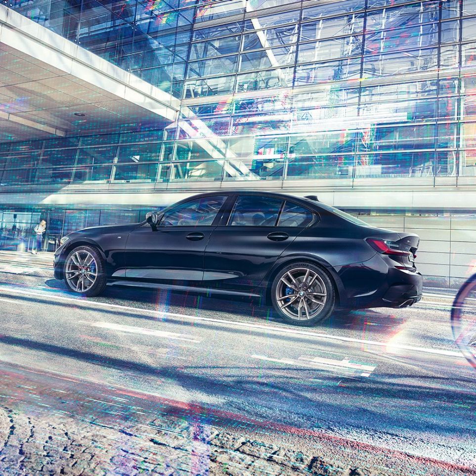 BMW 3-serie Sedan, BMW M340i xDrive. Stillastående BMW M340i xDrive från sidan framför byggnad i storstadsmiljö.