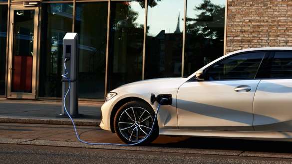 Laddhybrid BMW 3-serie Sedan 2021 G20 sedd från sidan Laddhybrid BMW 3-serie Sedan 2021 G20 sedd från sidan vid laddstation