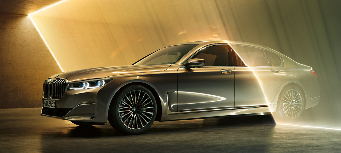 BMW 7 Series Sedan in three-quarter front view BMW 7 Series Sedan: grey BMW in three-quarter front view surrounded by beam of light