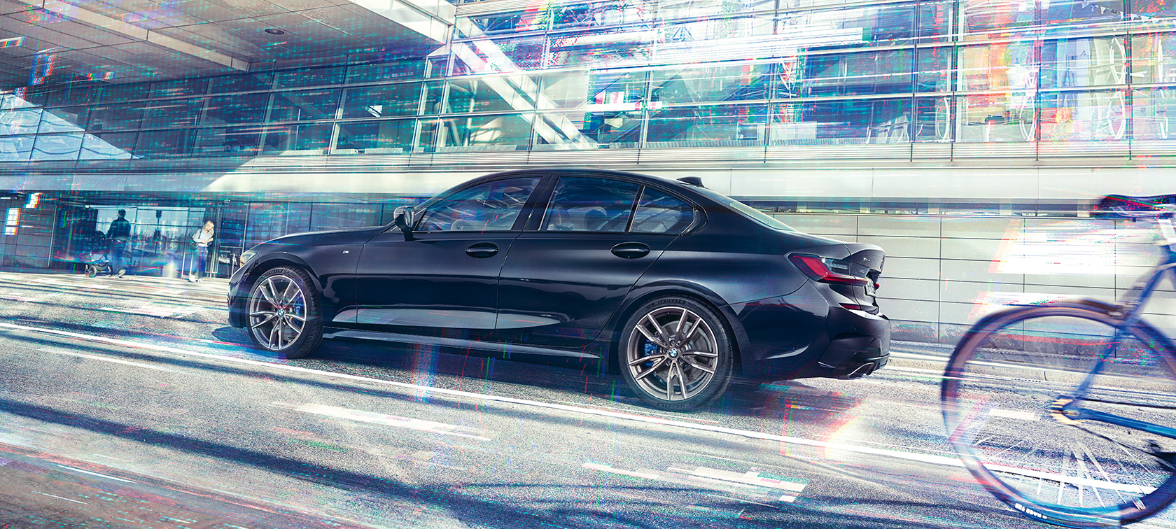 BMW M340i xDrive Sedan G20 2020 sedd från sidan körandes BMW M340i xDrive Sedan G20 2020 Safirsvart metallic sedd från sidan körandes