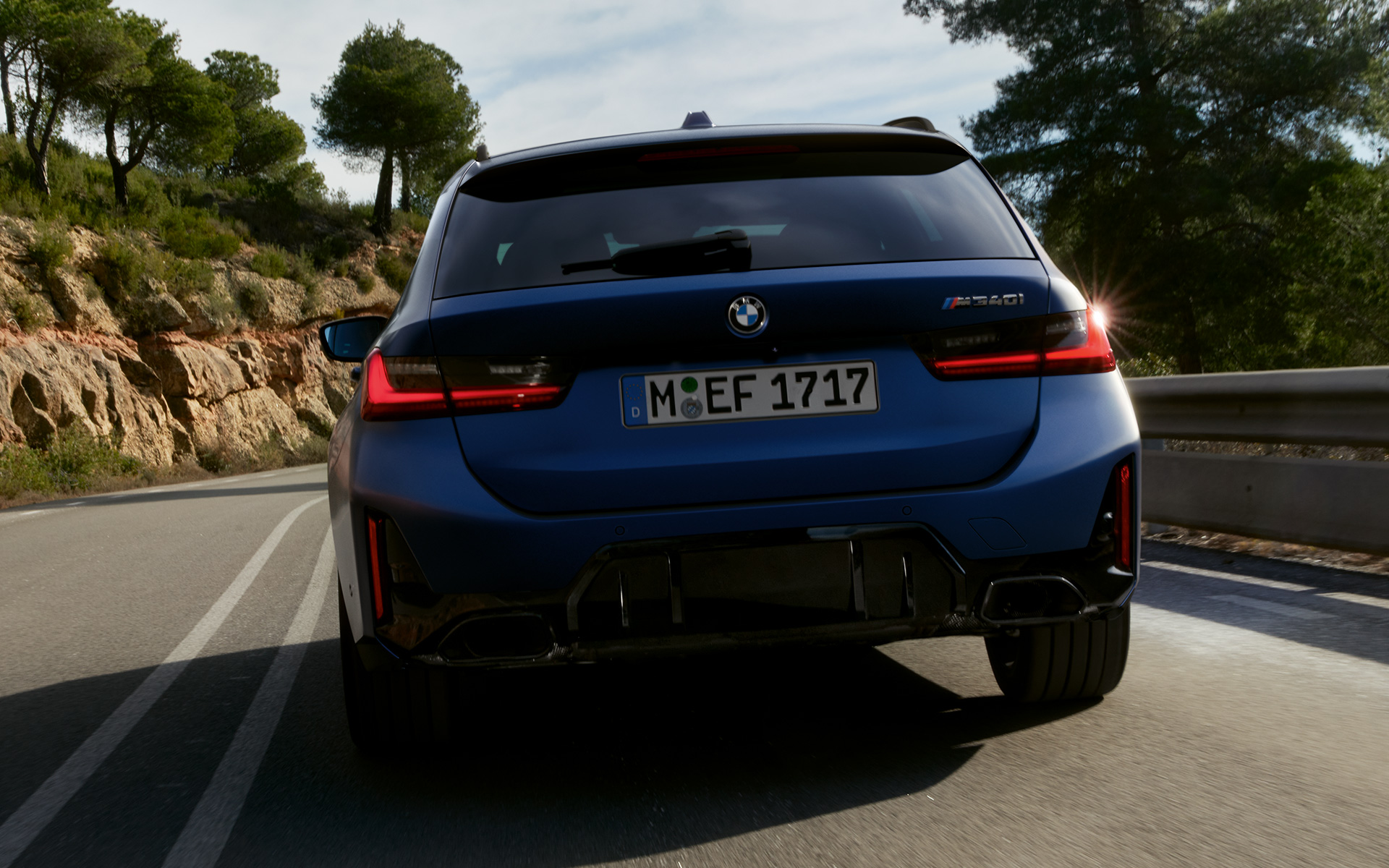 BMW M340i xDrive Touring G21 Frozen Tanzanite Blue sedd bakifrån körande på väg
