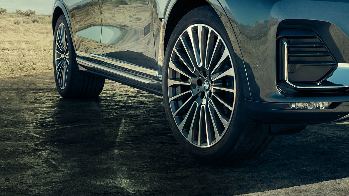 22'' lättmetallfälgar 22'' lättmetallfälgar: BMW X7 snett framifrån med fokus på hjulen