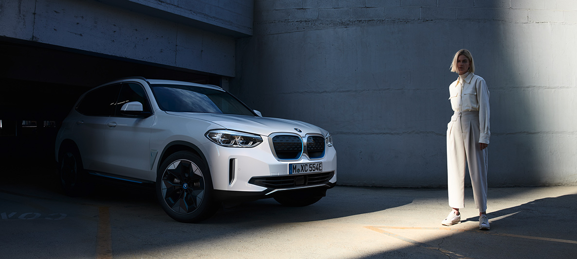 Kvinna framför BMW iX3 BMW EfficientDynamics kvinna framför BMW i3